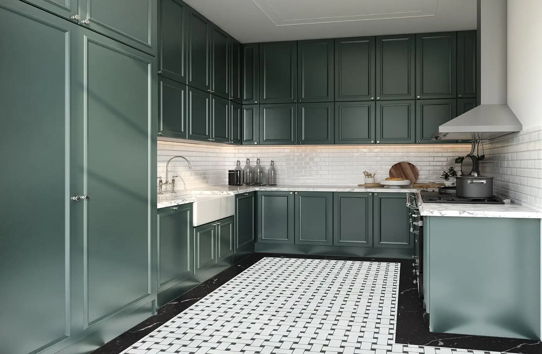 An image of a kitchen with dark green detail shaker cabinets, black and white penny tile flooring, strainless steel appliances, and a white apron front sink.