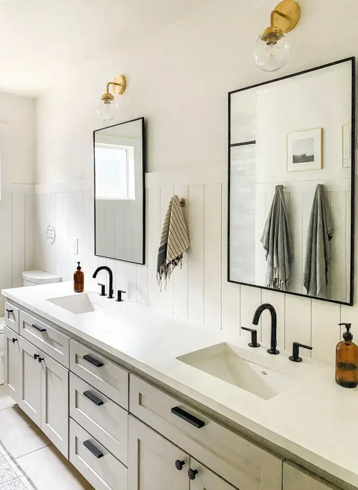 An image of a bathroom vanity with concrete countertops and shallow shaker taupe cabinet doors.