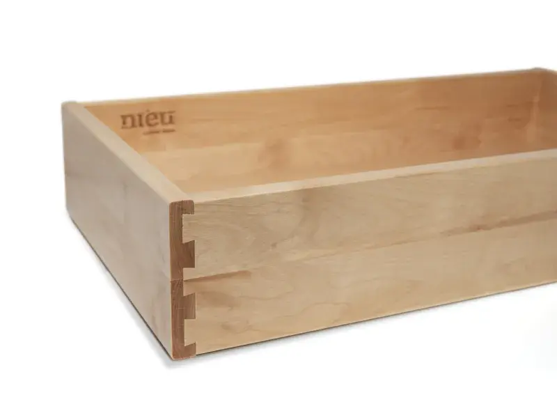 An image of a dovetail drawer box showing the dovetail joinery and laser etched logo.