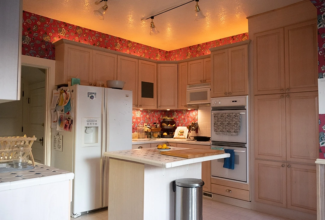 A u-shaped kitchen with dated honey oak raised panel cabinet doors.