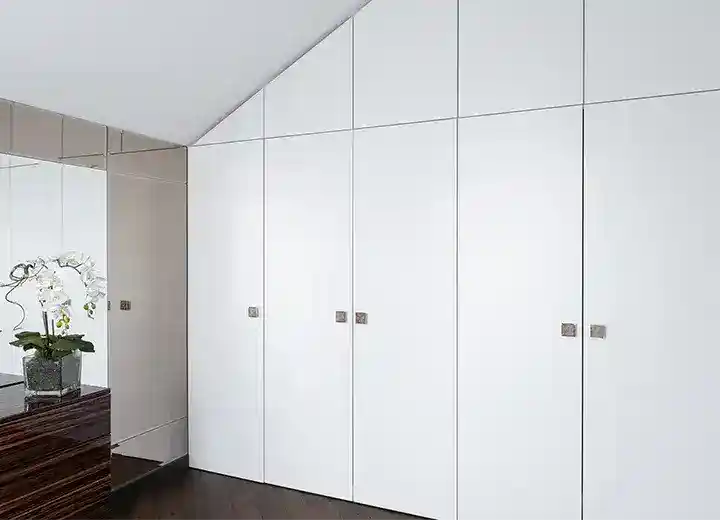 A photo of an IKEA Pax wardrobe with white slab cabinet doors.