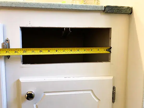 An image showing the inside frame width of a drawer opening on a bathroom vanity.