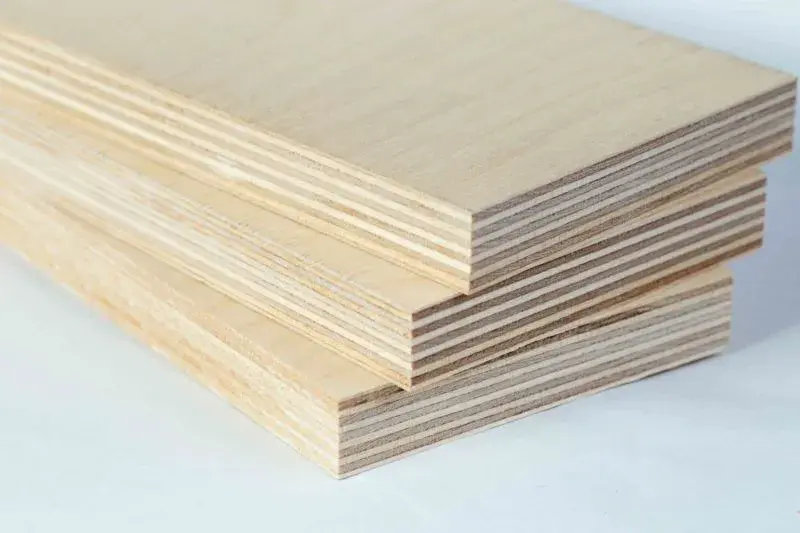 A closeup image of the side of sheets of plywood, showing its layers.