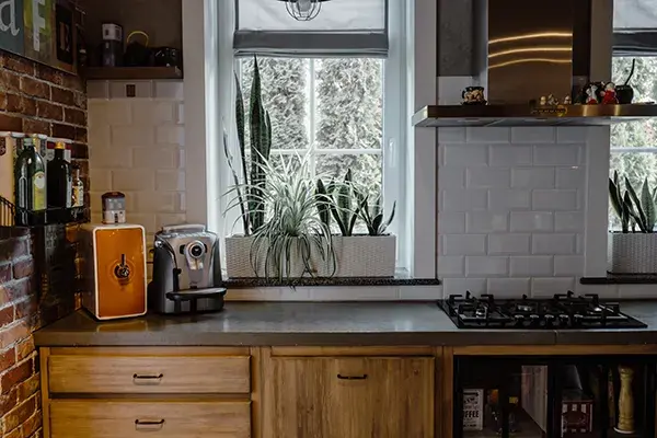 An image of a kitchen with oak cabinet doors and black hardware.